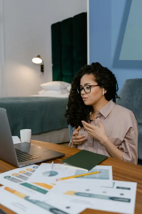 A stock photo of person desk using a laptop.