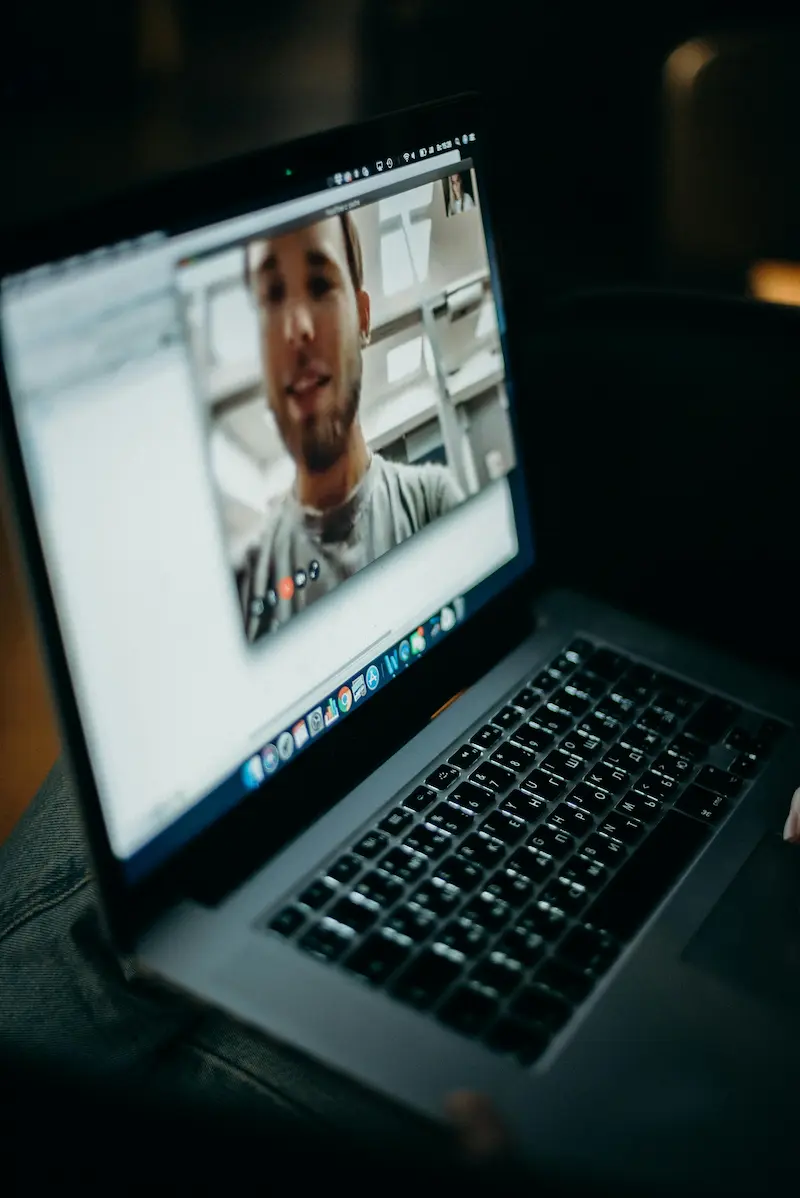 A stock photo of a laptop screen displaying a video call.